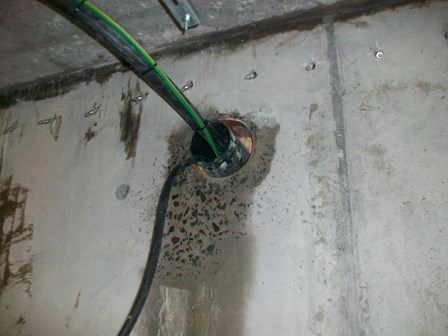 Water was seeping through the service duct, and into the basement.  Staining is visible on the concrete retaining wall, at Kells, Ballymena, Co. Antrim, NI