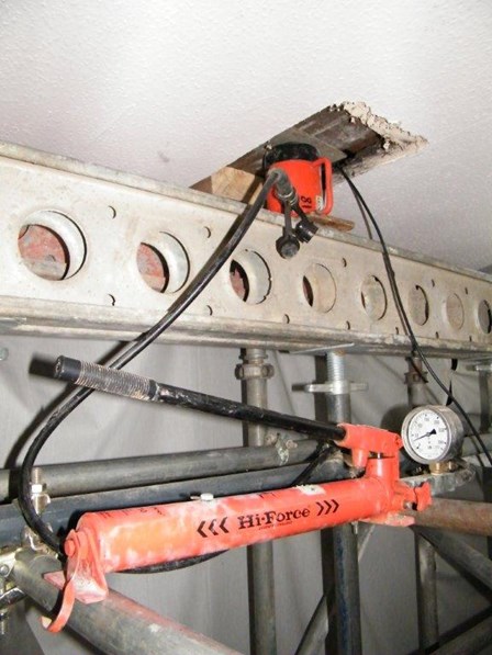 Realigning and lifting the trusses, using an hydraulic ram.  The trusses had slipped out of place due to the wet rot decay, at Falkirk, Stirlingshire, Scotland