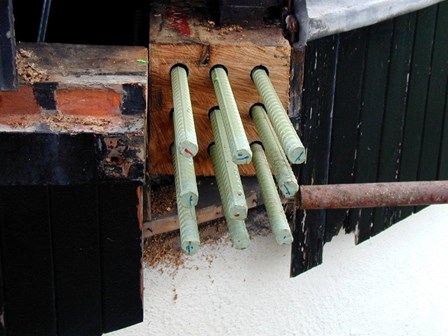 Steel bars inserted into reclaimed timber prior to splicing onto existing timber beams, originally affected by wet rot, at Millisle, Co. Down, NI