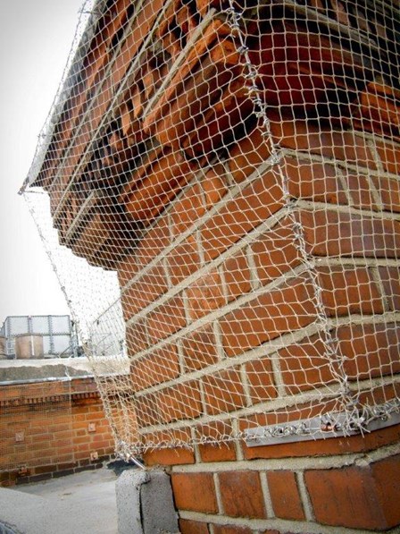 Discreet stainless steel masonry netting was fixed to the masonry, using rope access, to prevent falling masonry at Claridges Hotel, London, England