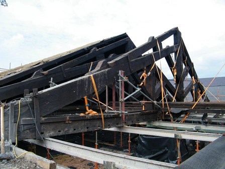 Roof trusses had slipped due to damp and wet rot.  Photo shows the trusses lifting into place, at First Derry Church, Londonderry, N. Ireland.