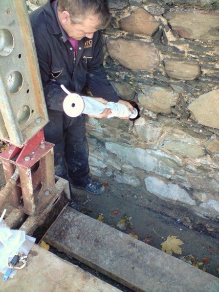 The grout is pressure pumped into the Cintec anchor at St Malachy's Wall, Bangor, Co. Down, NI.