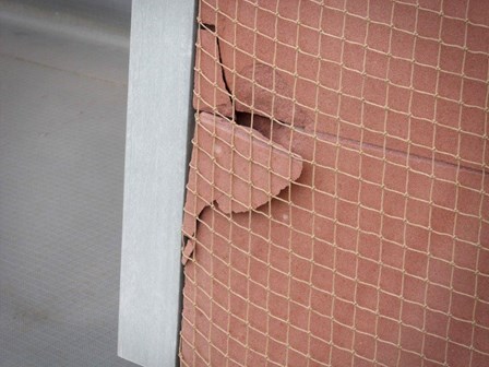 Portion of the stone cladding fragmenting, and posing a risk to the public below.  A masonry netting was fixed to the facade to prevent falling debris, at Jury's Inn, Liverpool, England