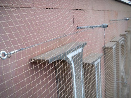 Masonry consolidation netting with stainless steel fixings by our rope access team, at Jury's Inn, Liverpool, England