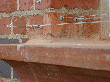 Discreet bird wire installed on window ledges at Portrush Town Hall, Co. Antrim, Northern Ireland.