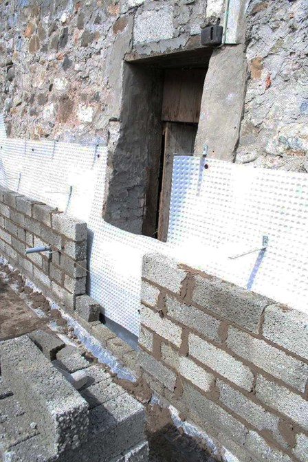 Cavity drain basement waterproofing membrane mechanically fixed to the walls below ground level, at Portrush Co. Antrim, Northern Ireland, NI